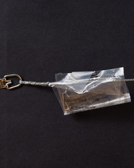 Wire hanger with plastic bag containing nail and hook on back of framed art of St. Joseph Hawk made with "The Hawk Will Never Die"