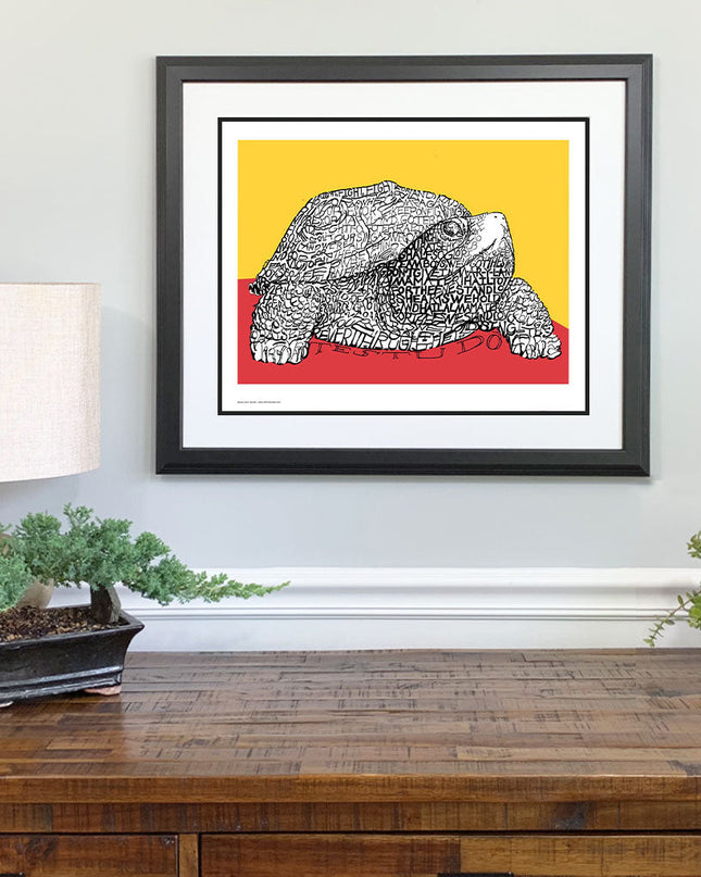 Framed red and yellow artwork of University of Maryland UMD Testudo mascot made of hand drawn lyrics of alma mater on wall.